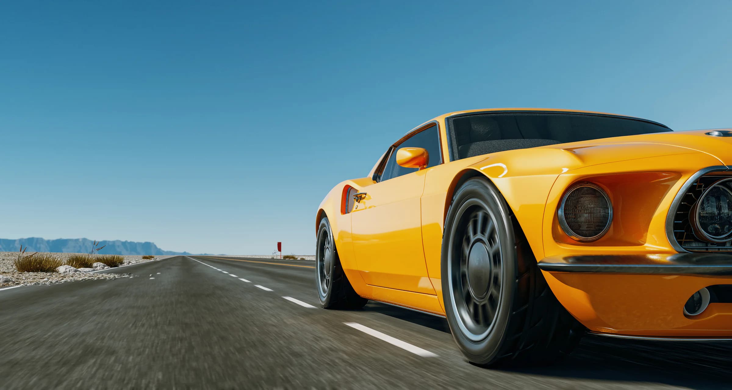 Orange performance car moving along an open mountain road