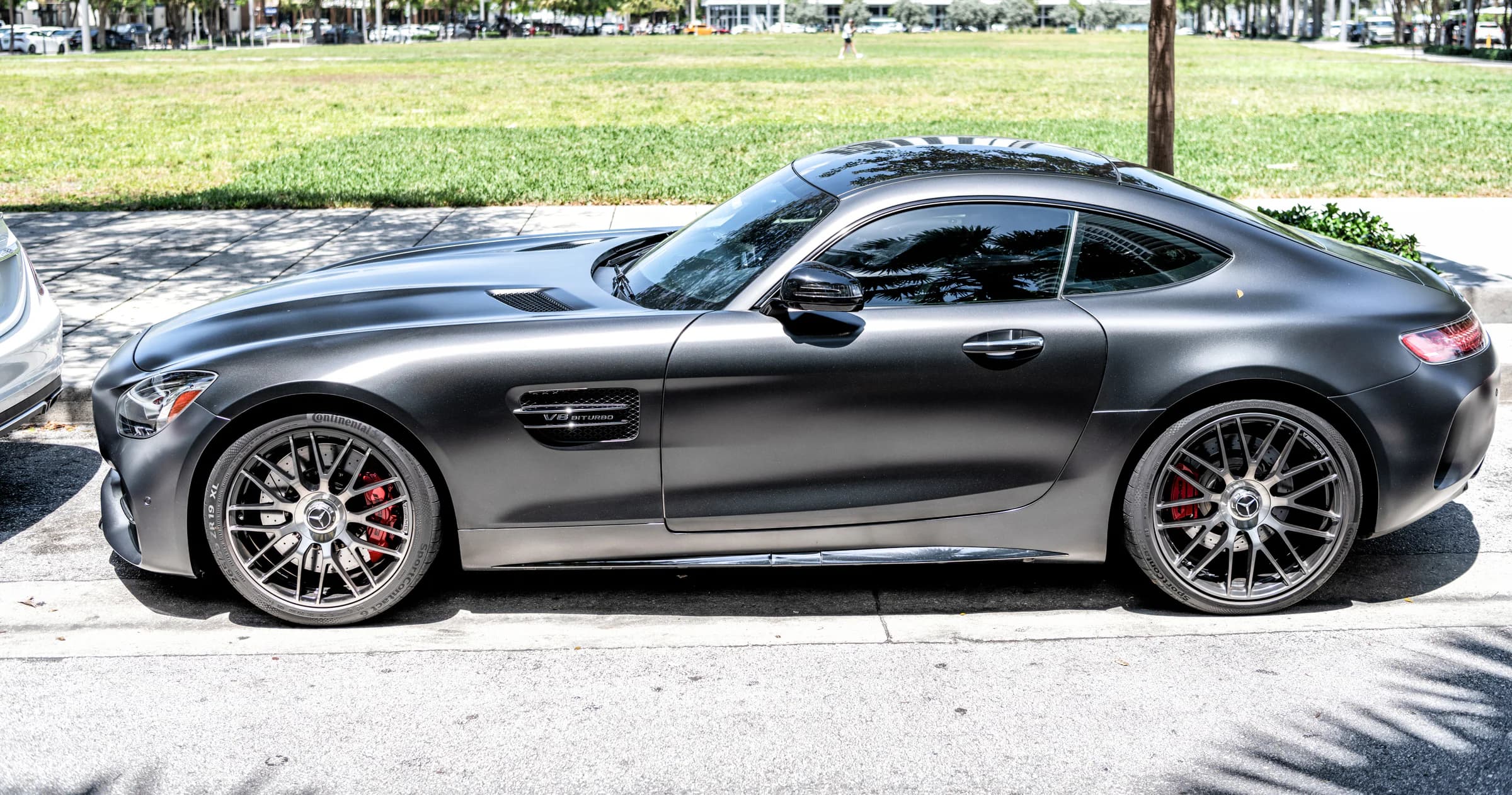 Matte graphite sports car in an urban setting; finish reference