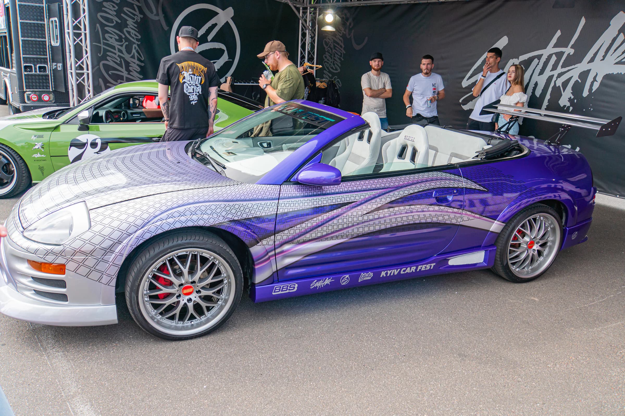Purple wrapped sports car displayed outdoors; finish reference